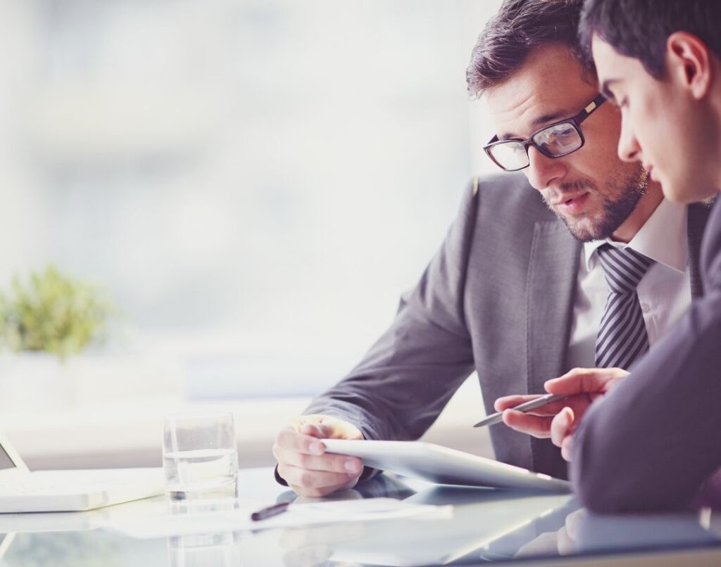 Two business men checking through information on an Ipad