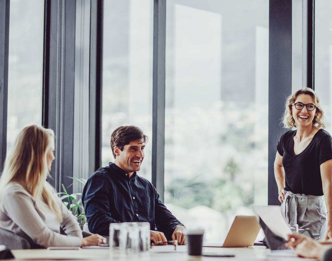 Meeting room of professionals talking and smiling