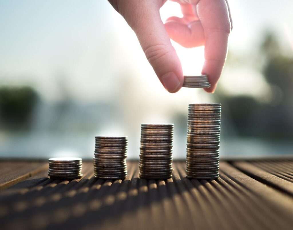 Hand stacking coins in columns