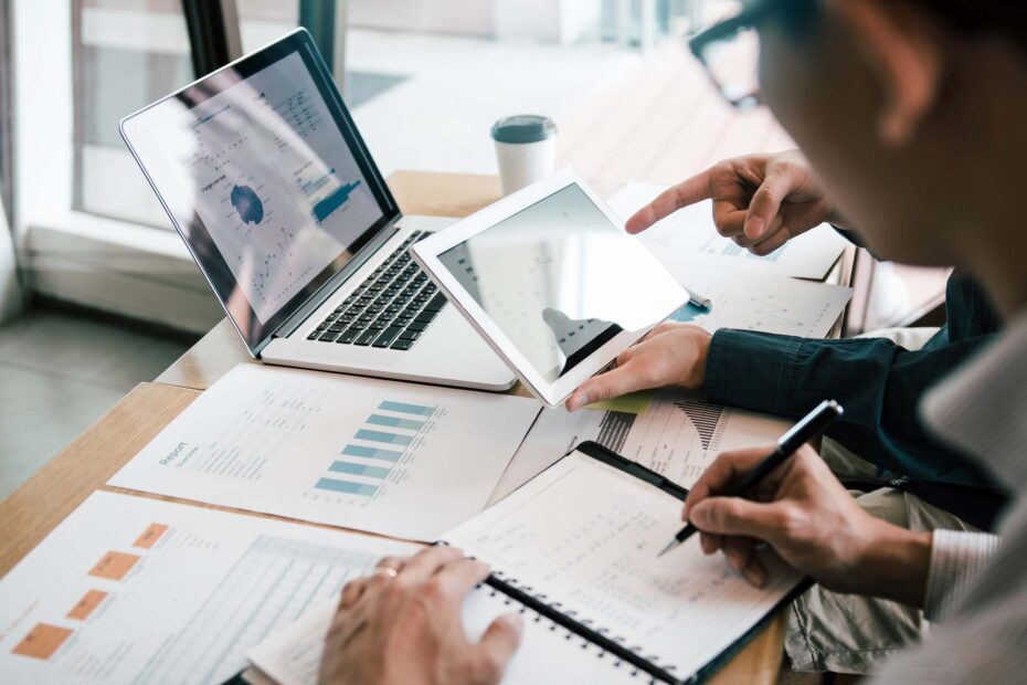 Two people studying budgets