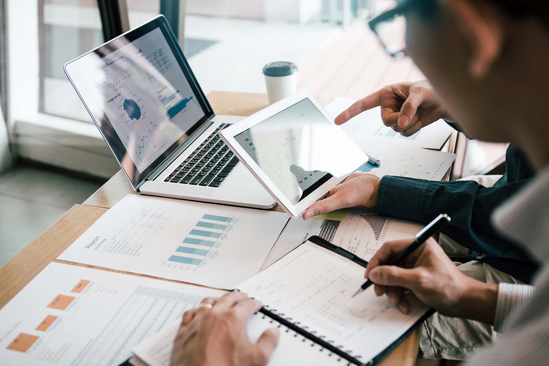 Two people studying budgets